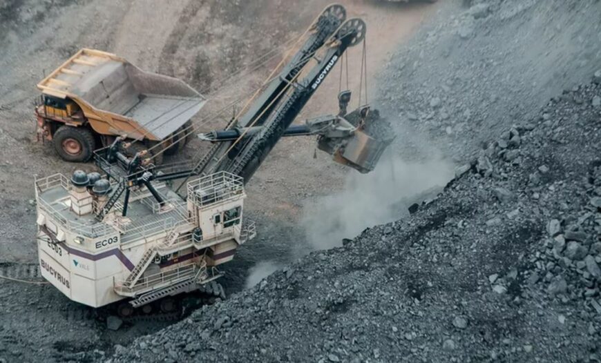 a dump truck is dumping gravel into a pile